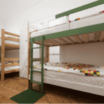 A college dorm room with two sets of bunk beds against the wall.