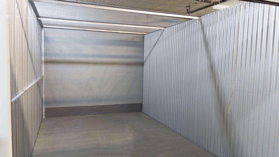 A view inside a large storage unit that is empty and clean