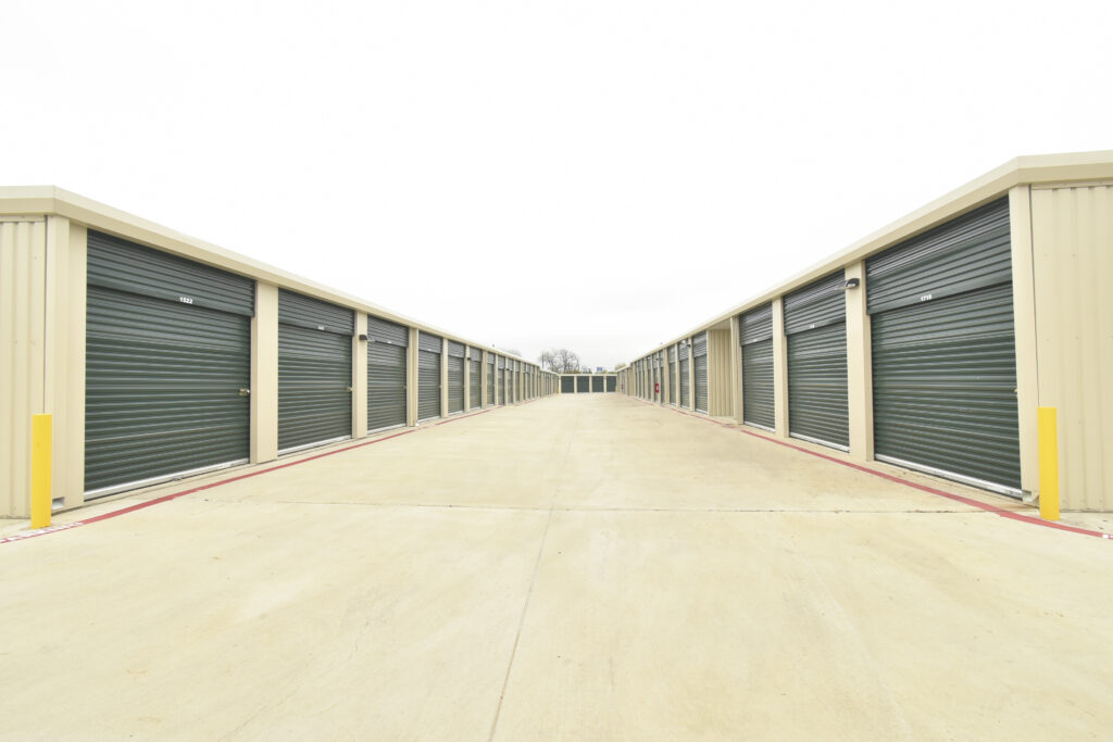 An exterior photo of the Five Star Storage facility's drive-up access storage units and their respective entry doors.