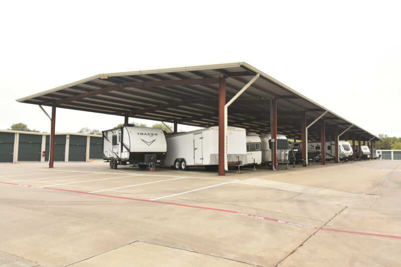 RVs and trailers sit underneath a covered shelter