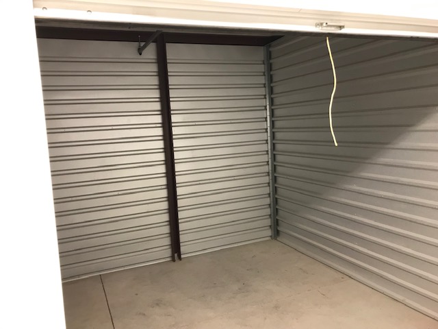 A view inside an outdoor storage unit that is empty and clean