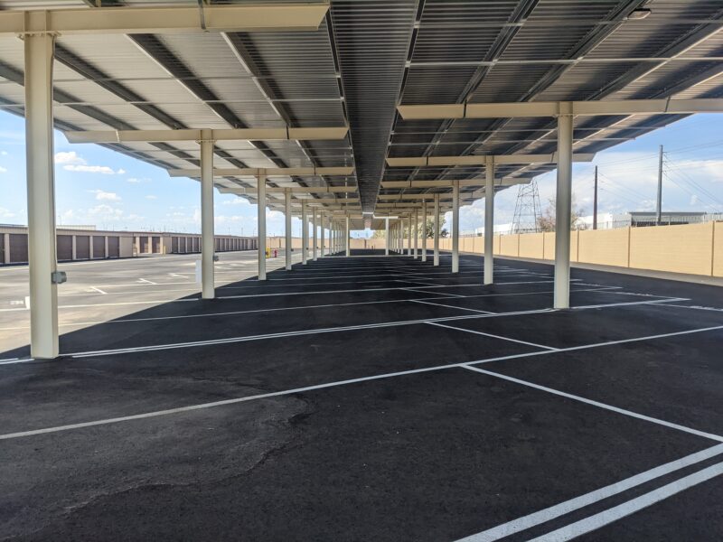 A row of covered RV parking spaces at River Crossing Avondale Storage & RV