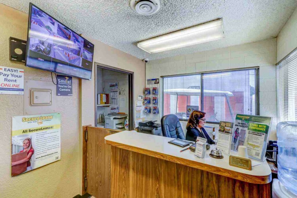 Inside storage facility front office overlooking the front desk with a television monitoring security