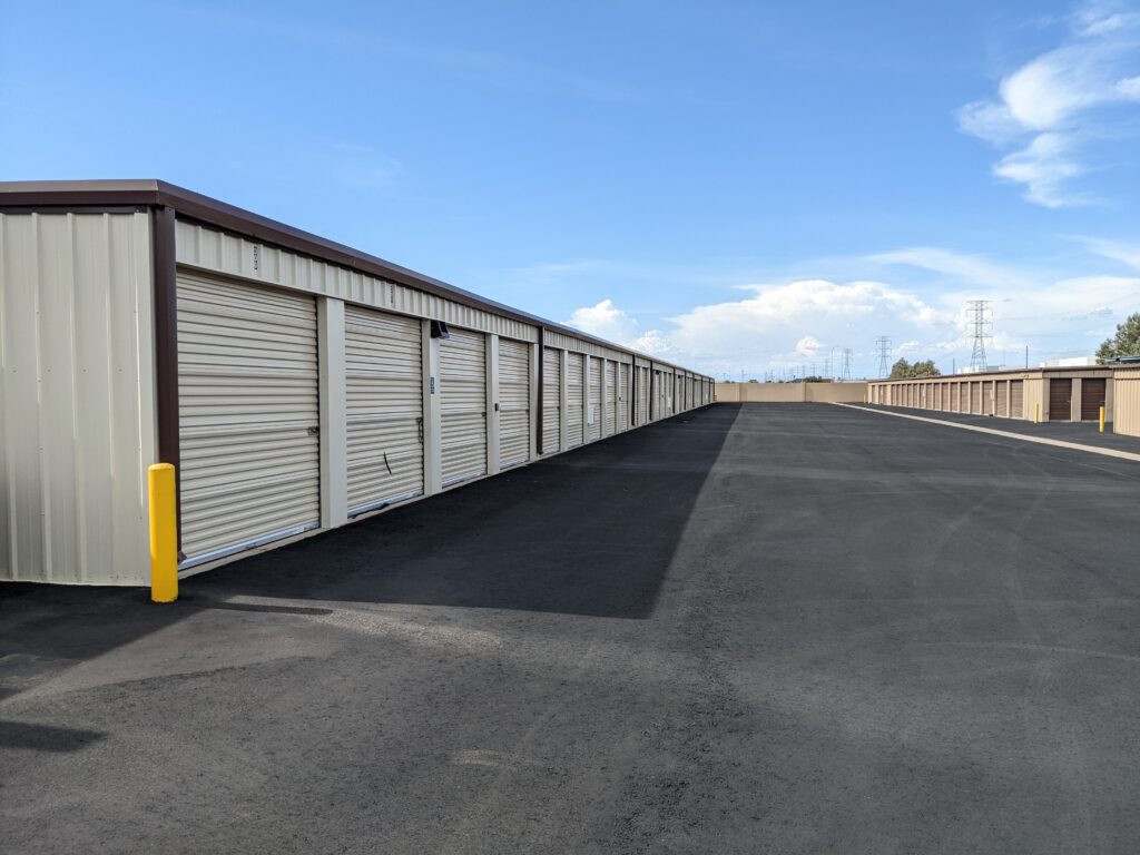 A wide aisle of outdoor storage units at River Crossing Avondale Storage & RV