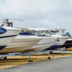 Outdoor parking area with boats lined up next to each other