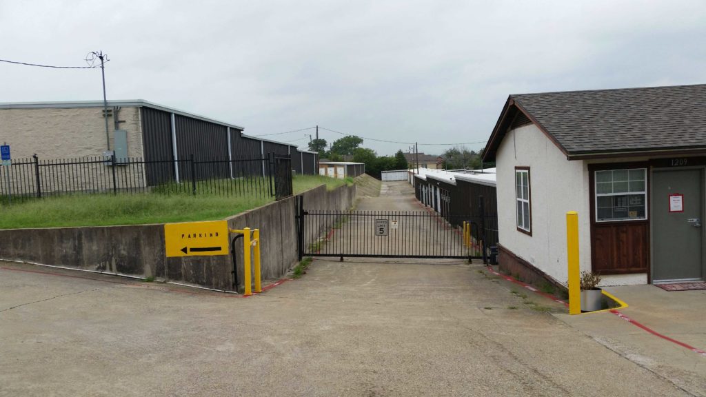 Storage office and gated entrance to outdoor storage unit area