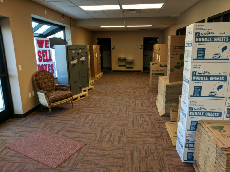 Indoor office area with moving boxes for sale and a rest area