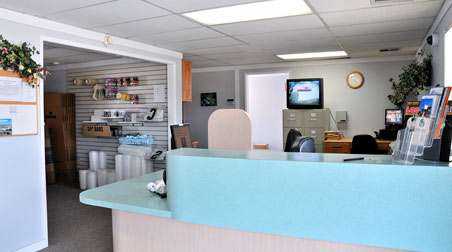 Front desk area of facility office with supplies