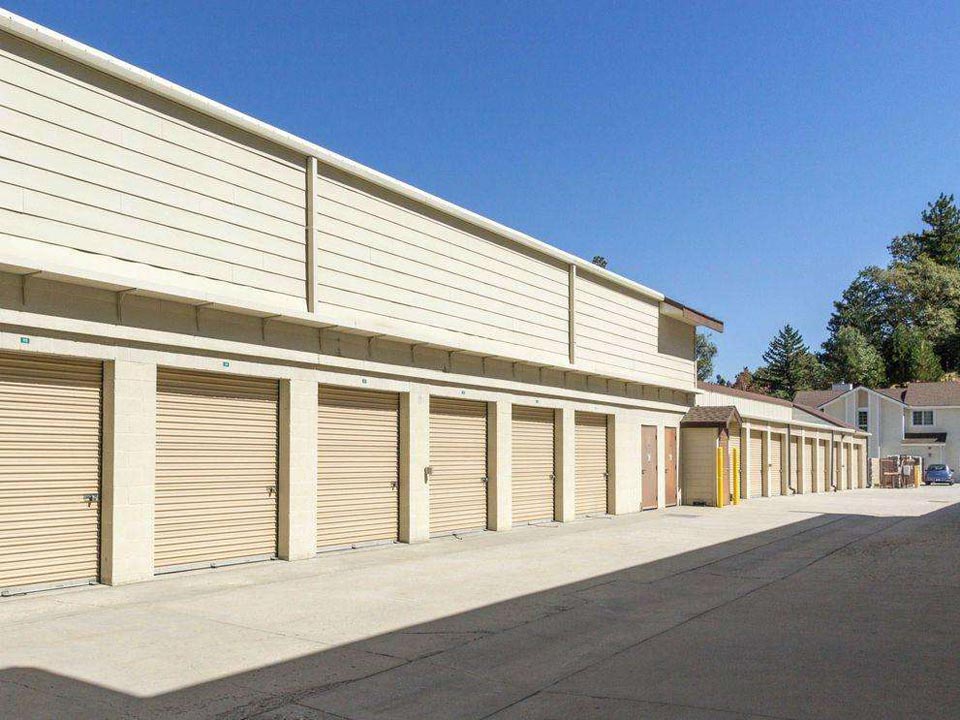 Outdoor storage units with yellow doors in a clean area