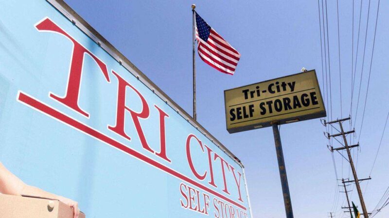 An angled up view of a Tri-City Self Storage street sign