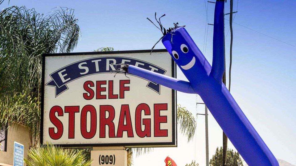 Street signage for E Street Self Storage with an inflatable by the sign