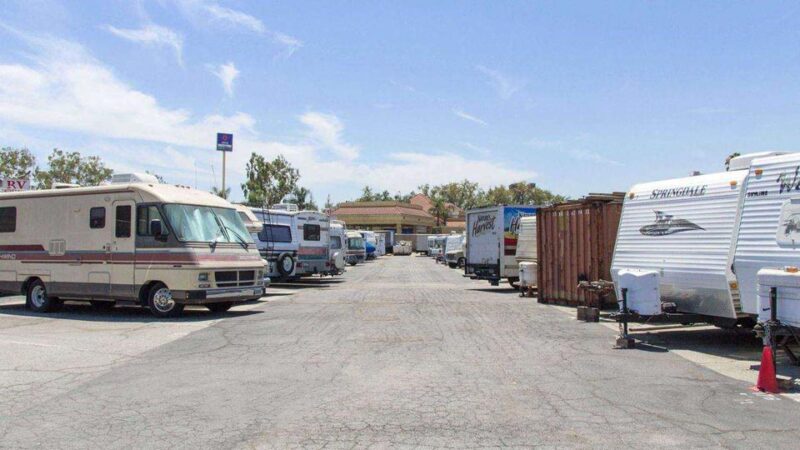 Large parking lot of RVs, trailers, and trucks parked outside