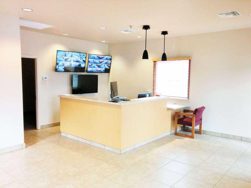Office front desk with video surveillance of storage facility