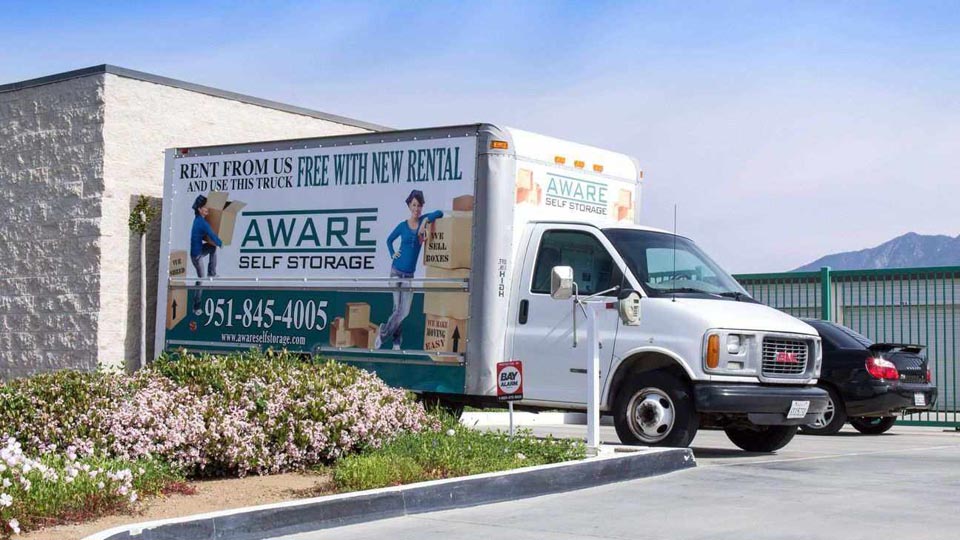 An Aware Self Storage moving truck parked in front of facility