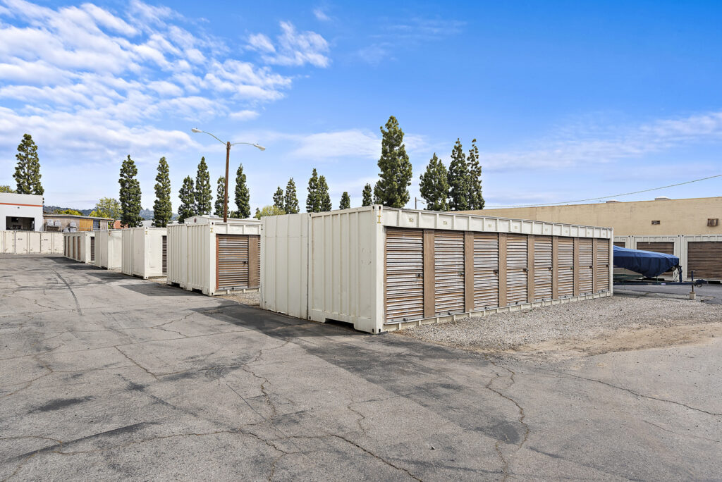 The exterior lot of the Lambert RV & Self Storage facility, featuring several rows of storage units and their respective entrances.