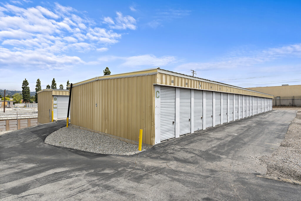 An exterior view of the Lambert RV & Self Storage facility's lot with several rows of storage units and their entrances.