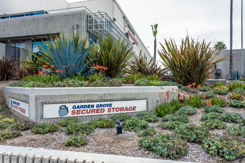 Signage and landscaping at the entrance of Garden Grove Secured Storage