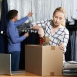 Small business owners pack up boxes and handle inventory in their shop