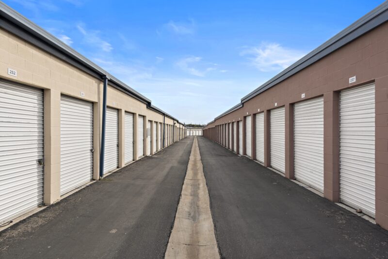 An eye-level perspective of one of the Allsize Self Storage facility driveways, consisting of secured storage units.