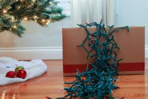 Tangled holiday lights spill over the edge of a cardboard box.