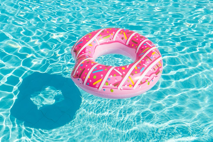 Colorful pink donut floaty in the pool.